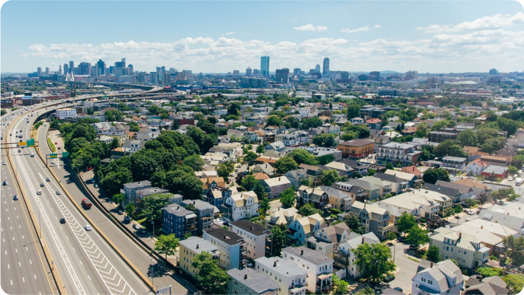 City highway and houses with skyline in the distance