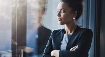 a wealth advisor standing next to a window